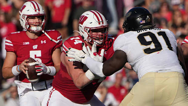 Wisconsin offensive lineman Michael Furtney blocking in front of Graham Mertz against Purdue.